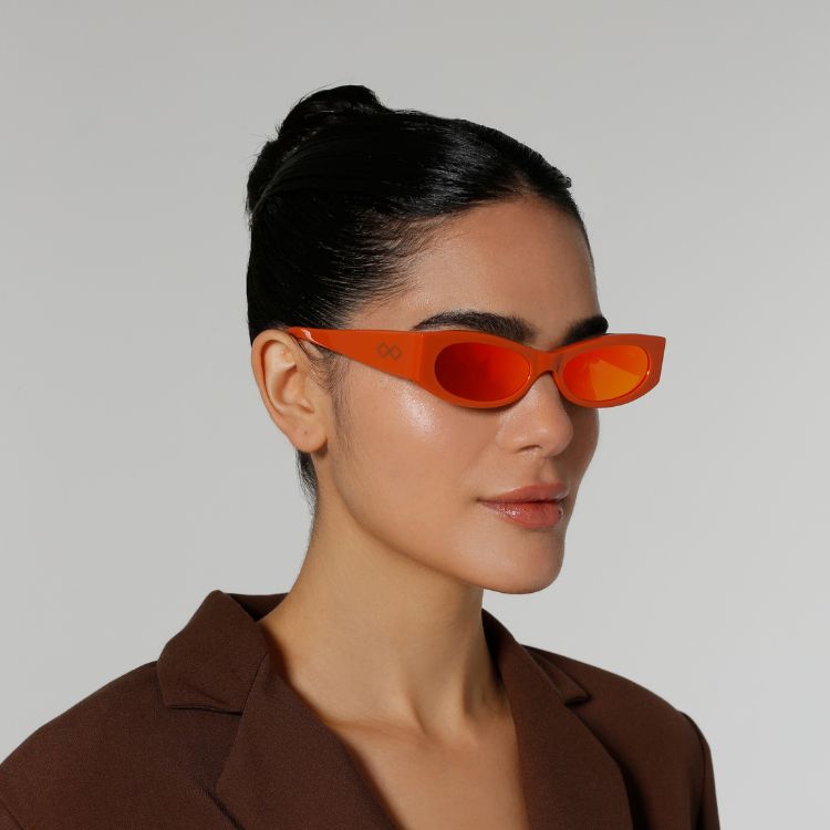 Side view of model wearing sunglasses | Cat-like sunglasses with orange mirror lenses and orange frames | Acetate | Ciara | Women's sunglasses | Karen Wazen Eyewear