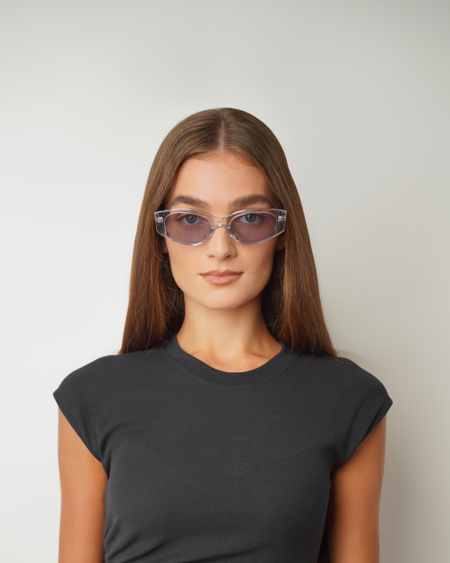 Front view of model wearing sunglasses | Cat-like sunglasses with clear lenses and clear frames | Acetate | Dixy | Women's sunglasses | Karen Wazen Eyewear