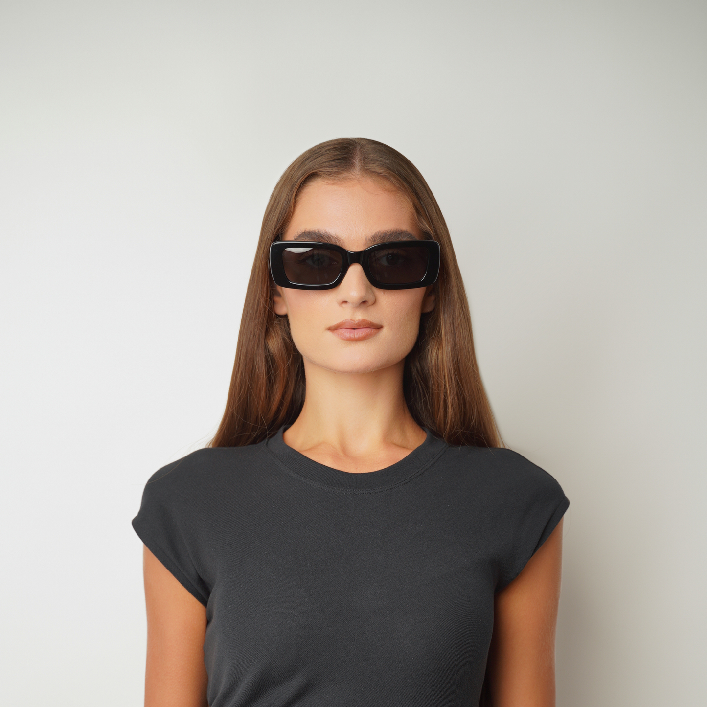 Front view of model wearing sunglasses | Rectangle round sunglasses with black lenses and black frames | Acetate | Kenny | Women's sunglasses | Karen Wazen Eyewear