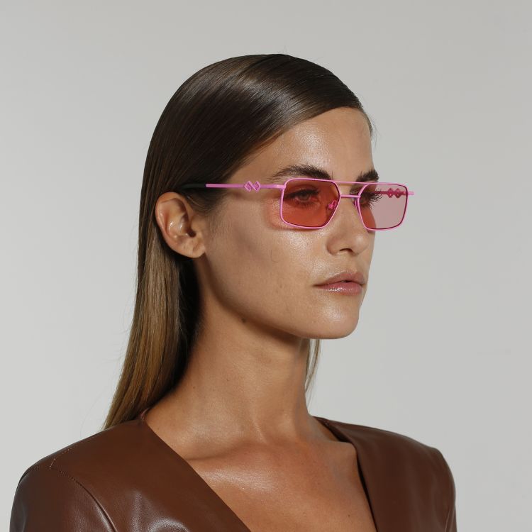 Side view of model wearing sunglasses | Rectangle sunglasses with pink lenses and pink frames | Metal | Devon | Women's, men's, and unisex sunglasses | Karen Wazen Eyewear