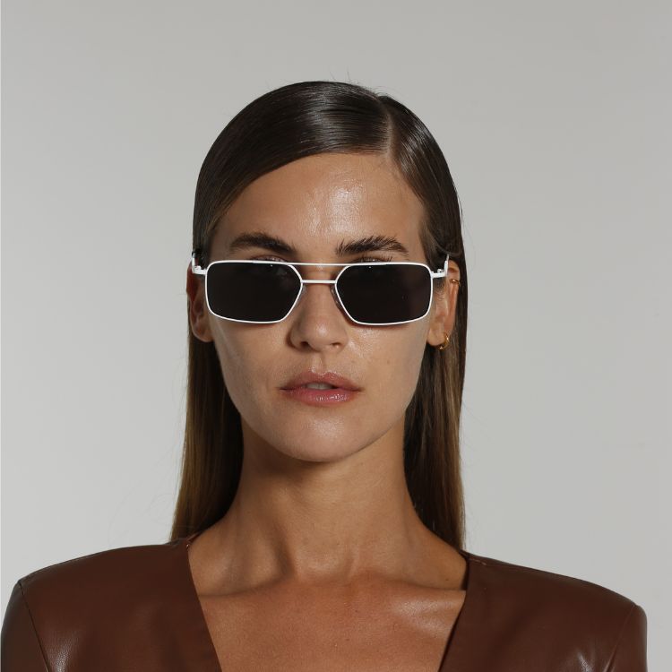 Front view of model wearing sunglasses | Rectangle sunglasses with black lenses and white frames | Metal | Devon | Women's, men's, and unisex sunglasses | Karen Wazen Eyewear