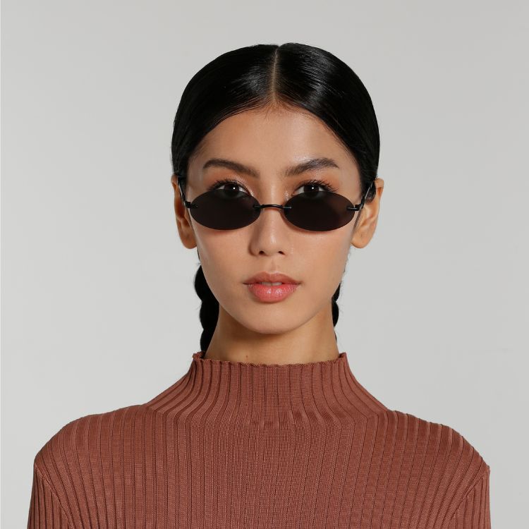Front view of model wearing sunglasses | Oval sunglasses with black lenses and black frames | Metal | Vicky | Women's sunglasses | Karen Wazen Eyewear