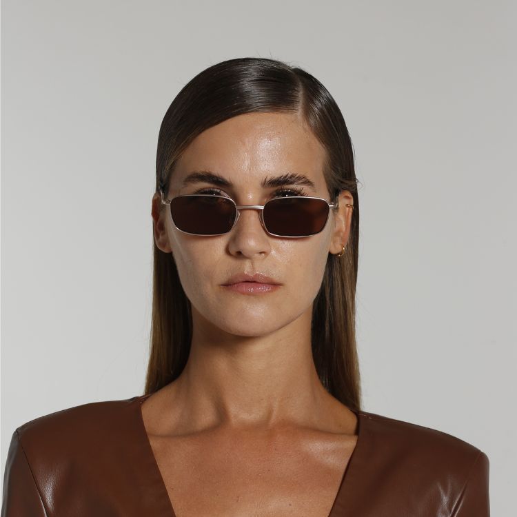 Front view of model wearing sunglasses | Rectangle sunglasses with brown lenses and gold frames | Metal | Ellis | Women's sunglasses | Karen Wazen Eyewear
