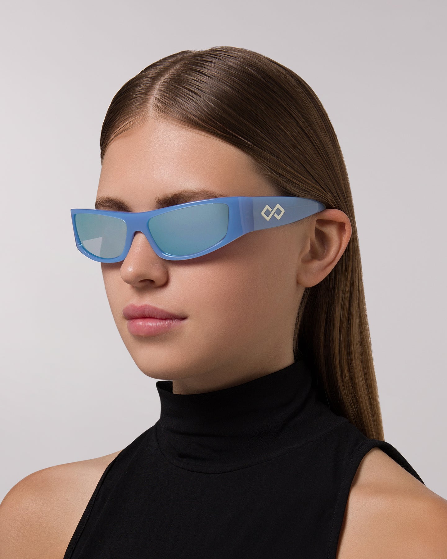 Side view of model wearing sunglasses | Rectangular sunglasses with mirror blue lenses and blue frames | Acetate | Sir | Women's sunglasses | Karen Wazen Eyewear