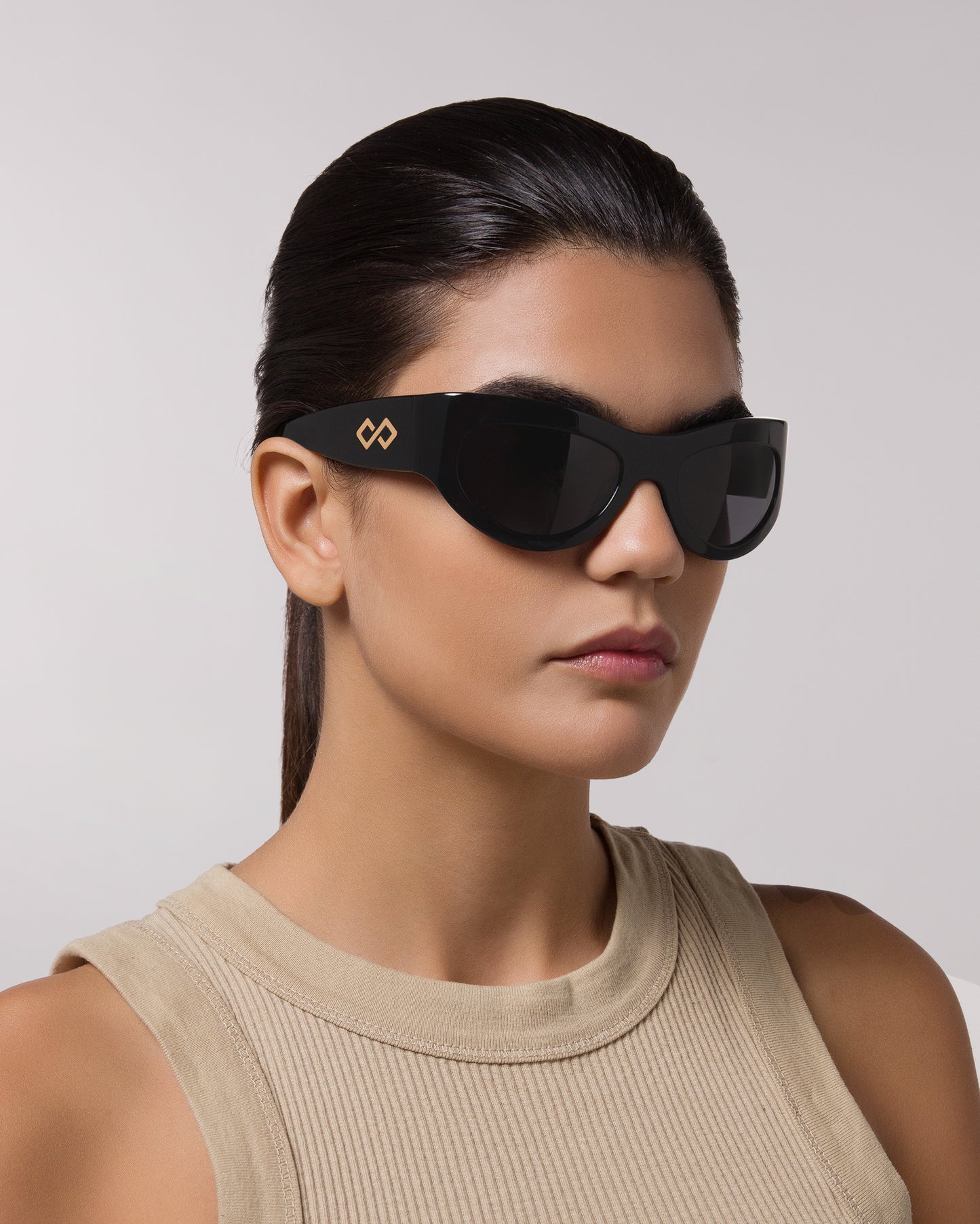 Front of model wearing sunglasses | Mask sunglasses with black lenses and black frames |  Acetate | Swim | Women's sunglasses | Karen Wazen Eyewear